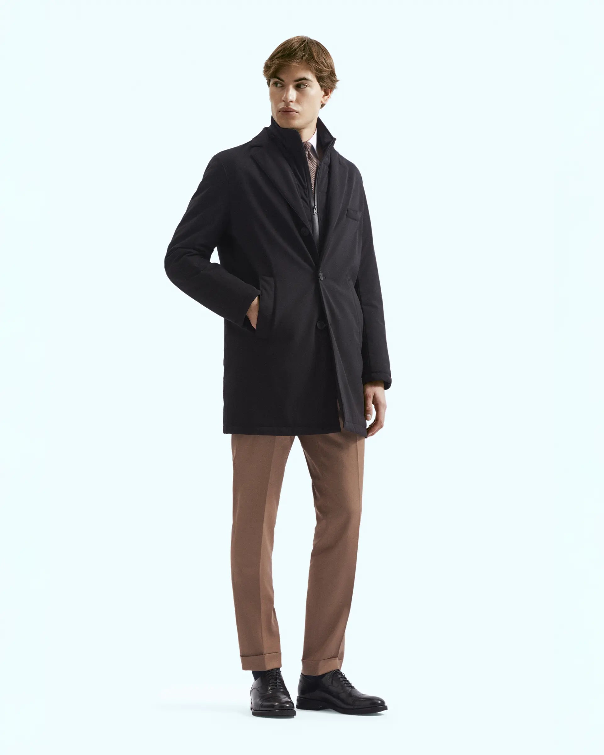 Black trench coat with bib in stretch technical fabric