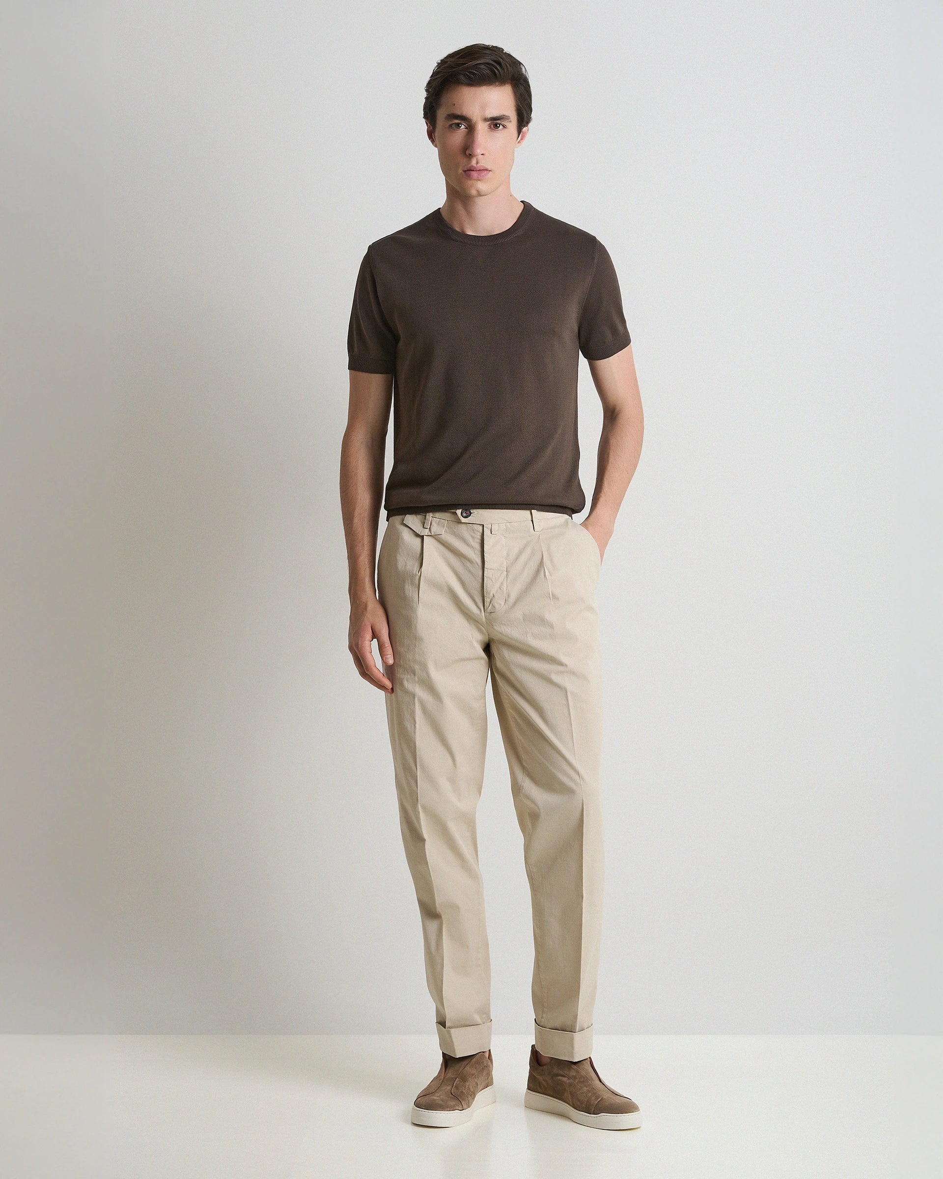 Beige stretch cotton carrot fit trousers with pleats and button placket