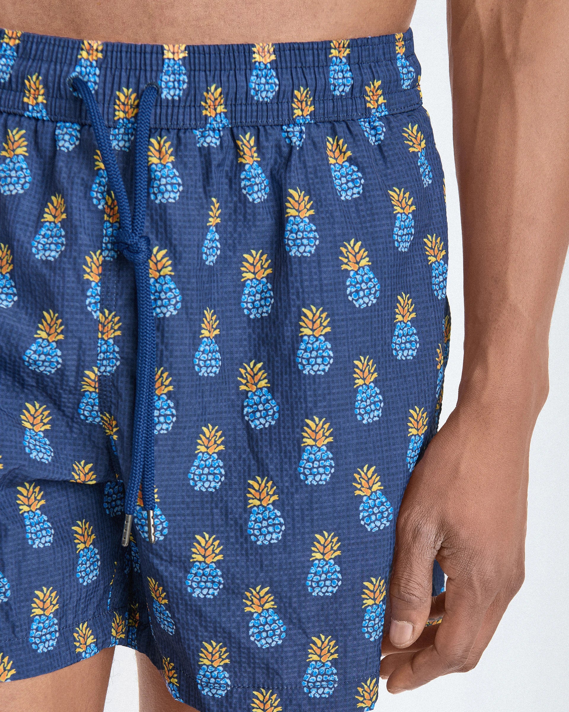 Patterned swim shorts with pineapple motifs