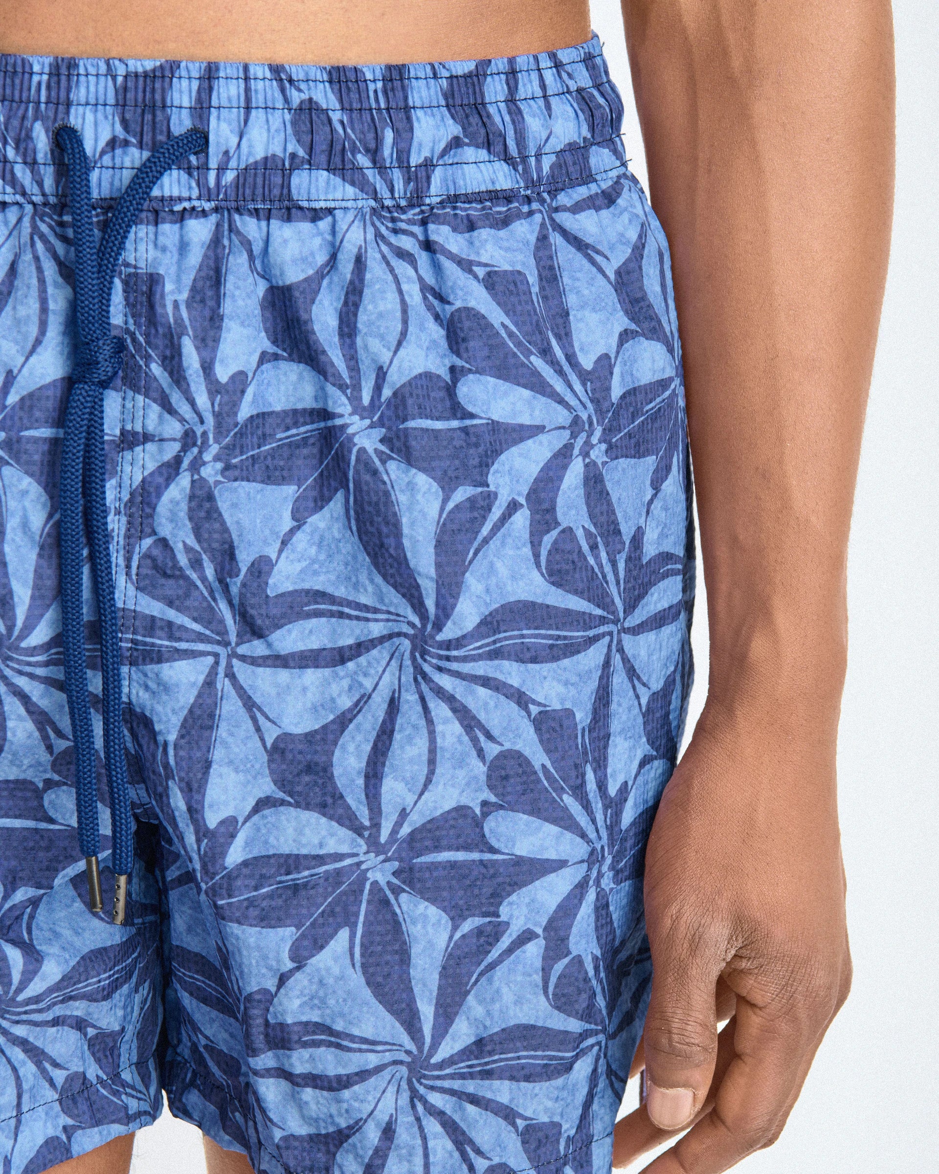 Patterned swim shorts with botanical motifs